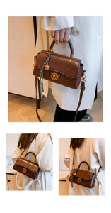 Detail of vintage brown leather bag with metal twist lock and checkered scarf charm