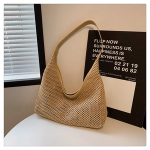 Detail of hand-woven beige hobo bag texture with slim leather shoulder strap