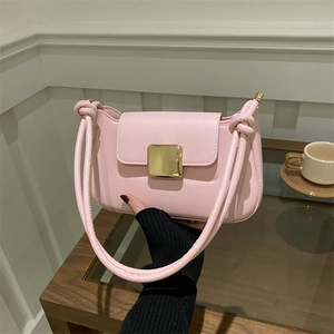Minimalist light pink shoulder bag with gold clasp and elegant knot strap detail