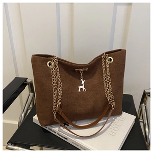 Brown frosted leather tote bag detail with gold chain strap and cute deer charm accessory