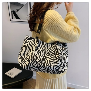 Retro zebra print canvas tote bag with black leather straps and gold metal hardware