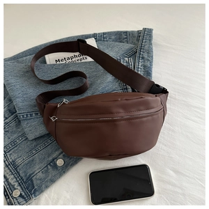 Detail of coffee brown waist bag showing internal capacity with a smartphone inside