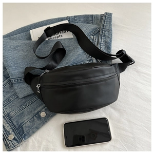 Detail view of black PU leather waist bag with silver dual zippers and nylon strap