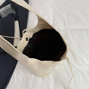 Minimalist cream tote bag with bow detail and spacious interior for daily commute