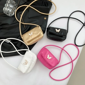 Quilted crossbody bag with bow buckle in gold, black, white and rose red colors
