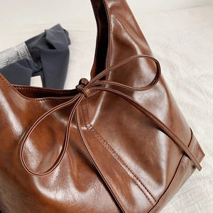 Brown vintage oil wax PU leather tote bag with elegant bow detail for women