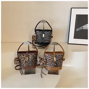 Fashionable leopard print bucket bags with metal locks and fluffy charms in three colors