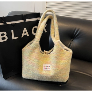 Dettaglio della borsa tote in maglia colorata con texture pastello e chiusura magnetica