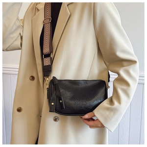 Detail of black Boston bag with textured leather, wide patterned strap and embossed fashion logo