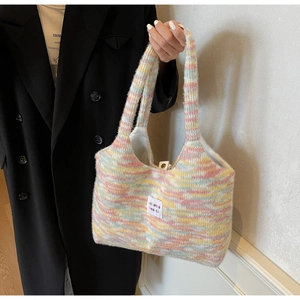 Dettaglio della borsa tote in peluche arcobaleno con fibbia magnetica e trama morbida