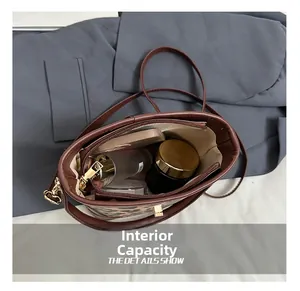 Detail view of leopard print bucket bag interior showing large capacity and inner pockets