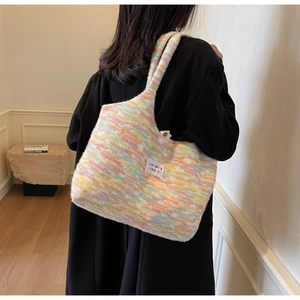 Dettaglio della borsa tote in maglia arcobaleno con etichetta del marchio tessuta