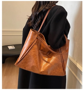 Detail of caramel brown tote bag with marble texture and long double shoulder straps