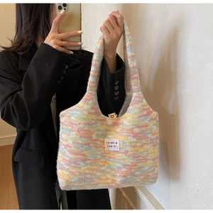Dettaglio della borsa tote in maglia arcobaleno con strisce e etichetta tessuta sozakka