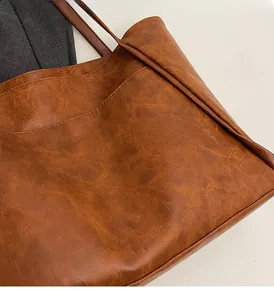 Macro detail of retro brown tote bag showing premium faux leather texture and stitching