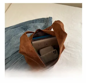 Interior view showing the large storage capacity of the brown suede tote bag