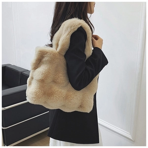 Close-up of a plush beige faux fur tote bag showing soft texture and large capacity