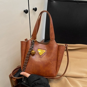 Vintage brown faux leather tote bag with gold triangle logo and tassel charm detail