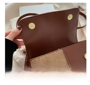 Close-up of golden magnetic buckle on vintage brown leather crossbody bag detail