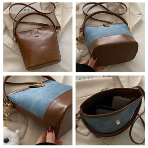 Detail view of denim and leather bucket bags with adjustable straps and metal buckles