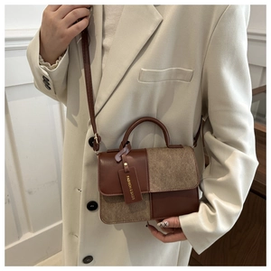 Close-up of a stylish crossbody bag with mixed brown leather and suede texture details