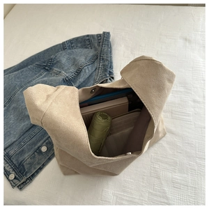 Detail of spacious beige matte tote interior with magnetic buckle and daily essentials