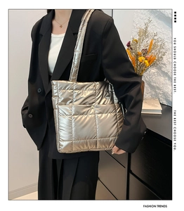Close-up of champagne gold quilted tote bag with metallic finish and soft texture