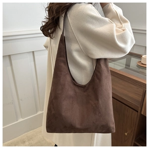Detail of a large vintage dark brown hobo tote bag in premium matte suede material