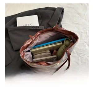 Detailed interior of a striped tote bag showing space for phone, umbrella, and wallet