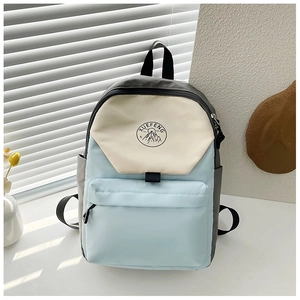 Close-up of a stylish patchwork backpack with XUEFENG mountain patch and front pocket
