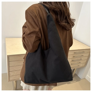 Side view of large black matte tote bag showing shoulder strap drop and spacious capacity