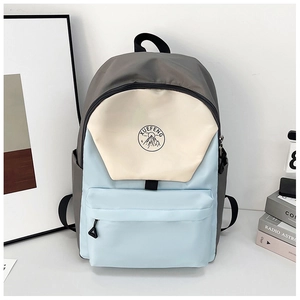 Close-up of tricolor nylon backpack with blue, white, and grey panels and side pocket