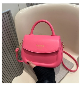 Detail of hot pink saddle bag featuring smooth PU leather and gold metal buckle