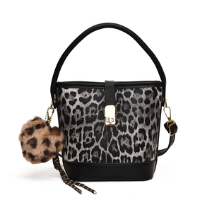 Trendy leopard print bucket bag with golden buckle and plush pompom charm decoration