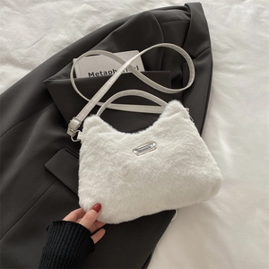 Détail du sac bandoulière en peluche blanche avec plaque sport et lanière en cuir