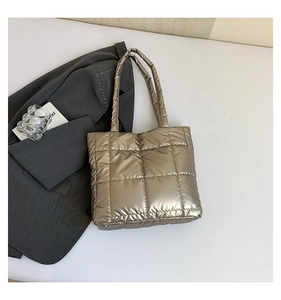 Close-up of champagne gold quilted tote bag with metallic texture and sleek finish