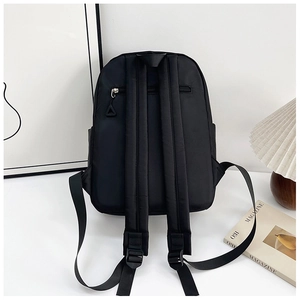 Detail of waterproof nylon backpack back showing padded straps and hidden anti-theft pocket