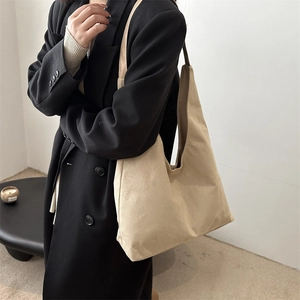 Minimalist beige suede hobo shoulder bag with large capacity and matte finish texture