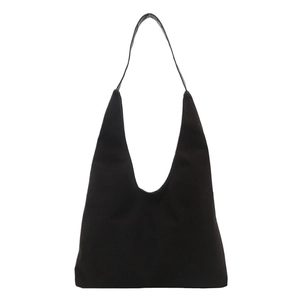 Minimalist black matte tote bag in hobo style with seamless shoulder straps on white background
