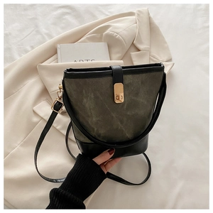 Detail of retro bucket bag with olive frosted texture and gold twist lock closure