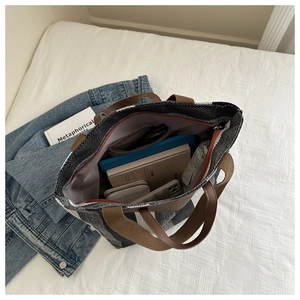 Detail view of large tweed tote bag interior showing spacious capacity for books and tablet