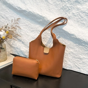 Detail view of caramel faux leather tote bag with a matching small zipper pouch