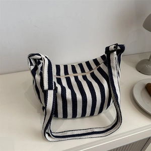 Navy blue and white striped canvas tote bag with adjustable shoulder strap and zipper
