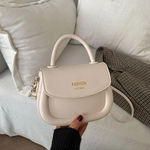 Elegant cream white faux leather saddle bag with gold logo and top handle for women
