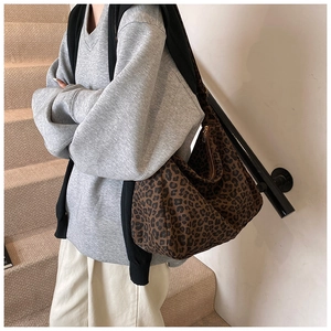 Detailed side view of leopard print bucket bag featuring a sturdy metal zipper closure