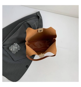 Overhead view of caramel tote bag with magnetic clasp and spacious interior