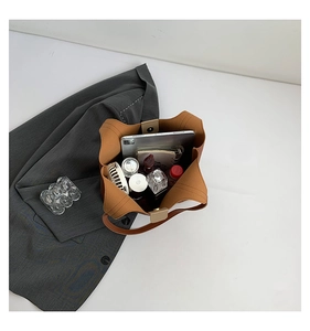 Top view of brown leather tote bag interior showing large capacity with daily essentials