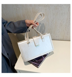 Detailansicht der weißen Handtasche aus geprägtem Kunstleder im schlichten Design