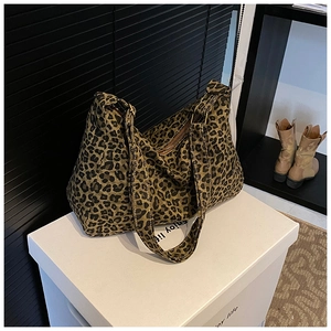 Detail shot of leopard print tote bag with thick fabric texture and zipper closure