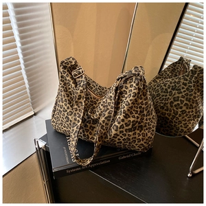Detailed shot of leopard print canvas tote bag with adjustable metal buckle and strap
